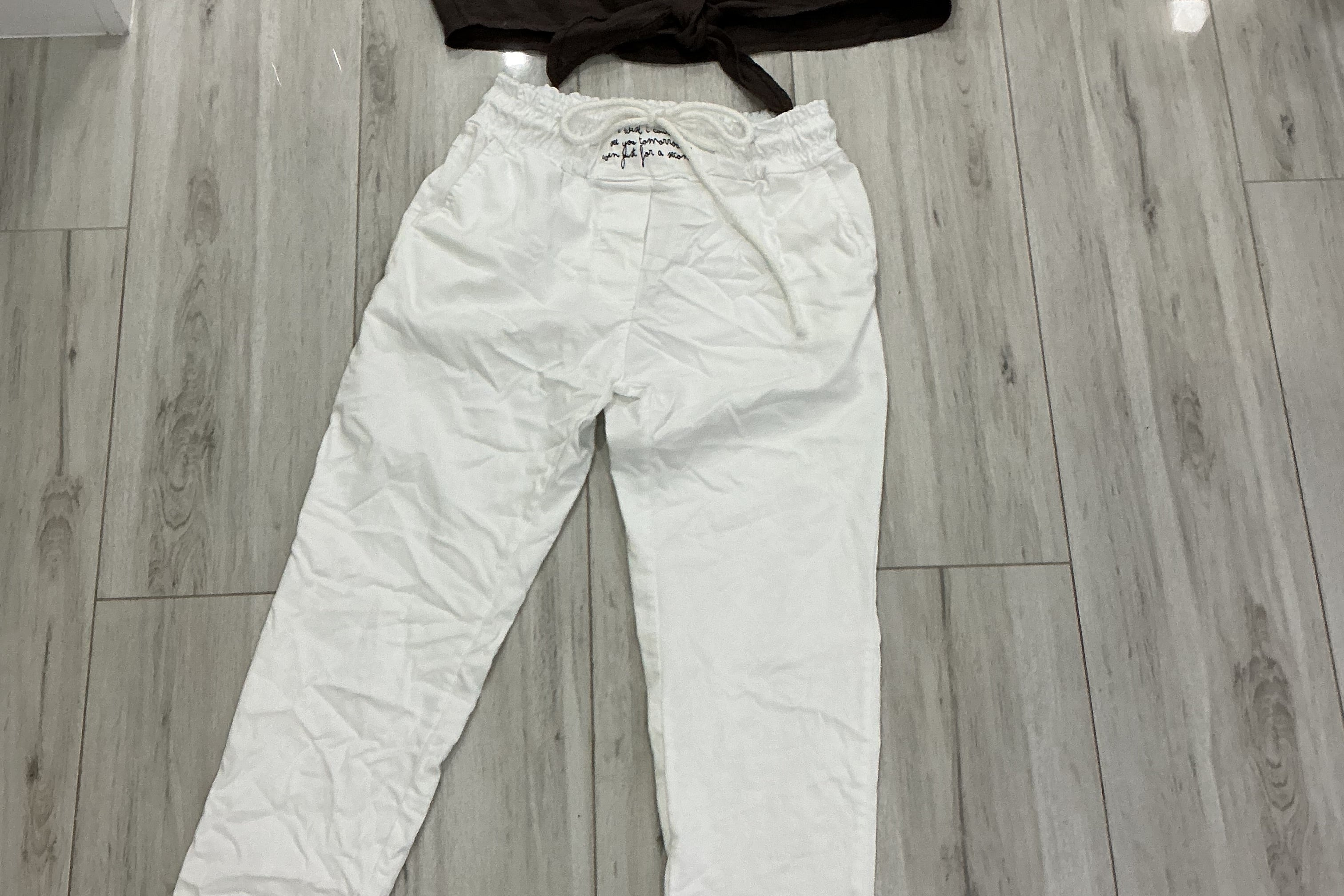 White pants on a wooden floor