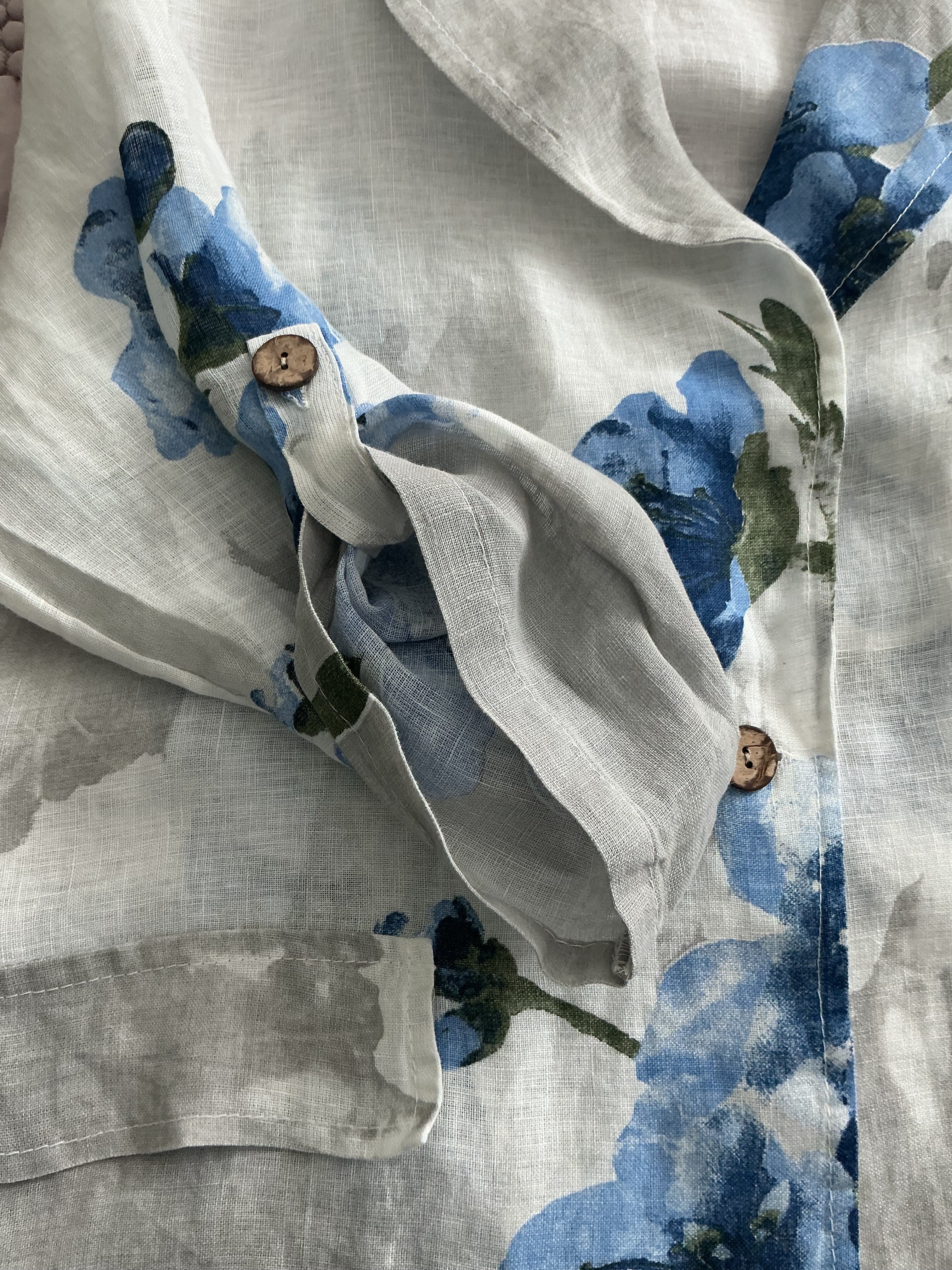 Close-up of a fabric with blue floral patterns on a textured background