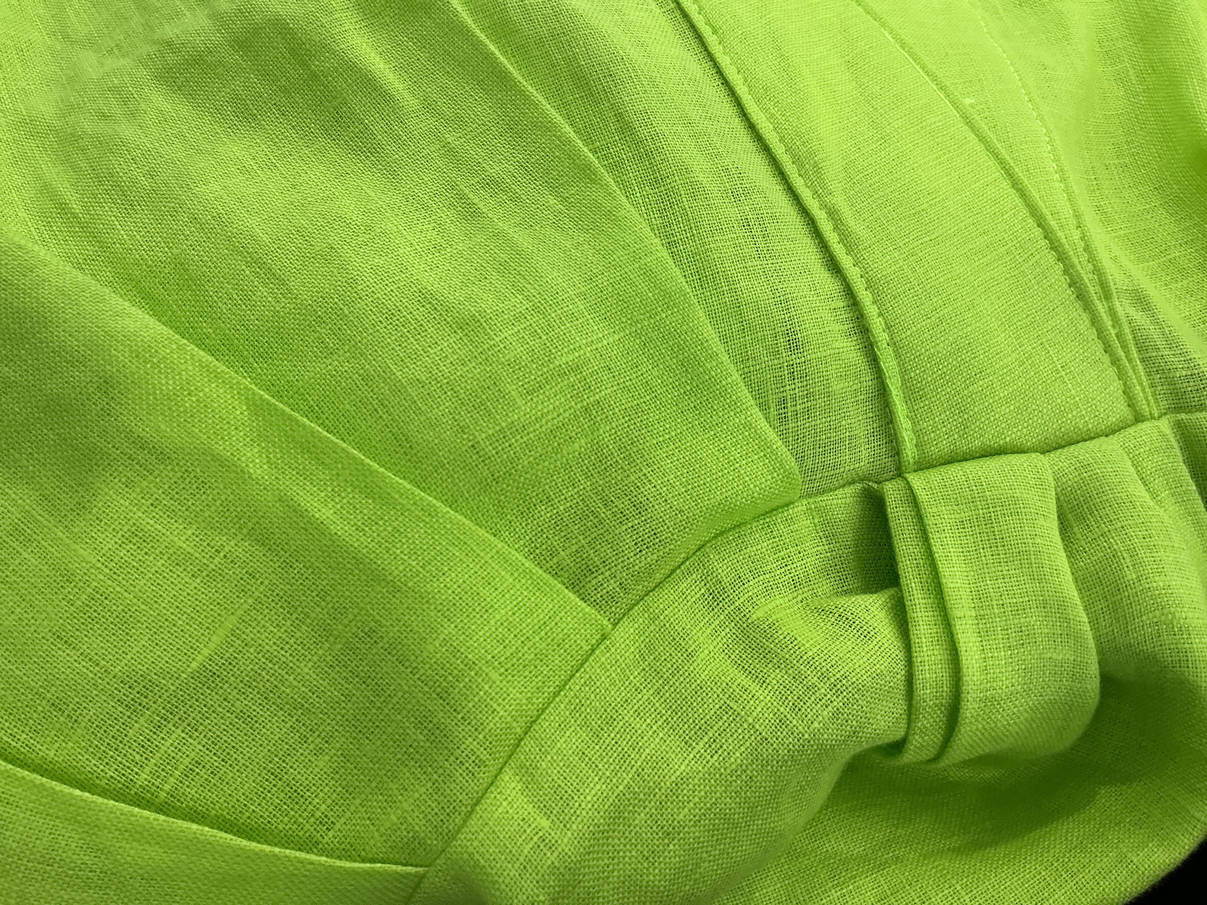 Close-up of green fabric with a bow detail
