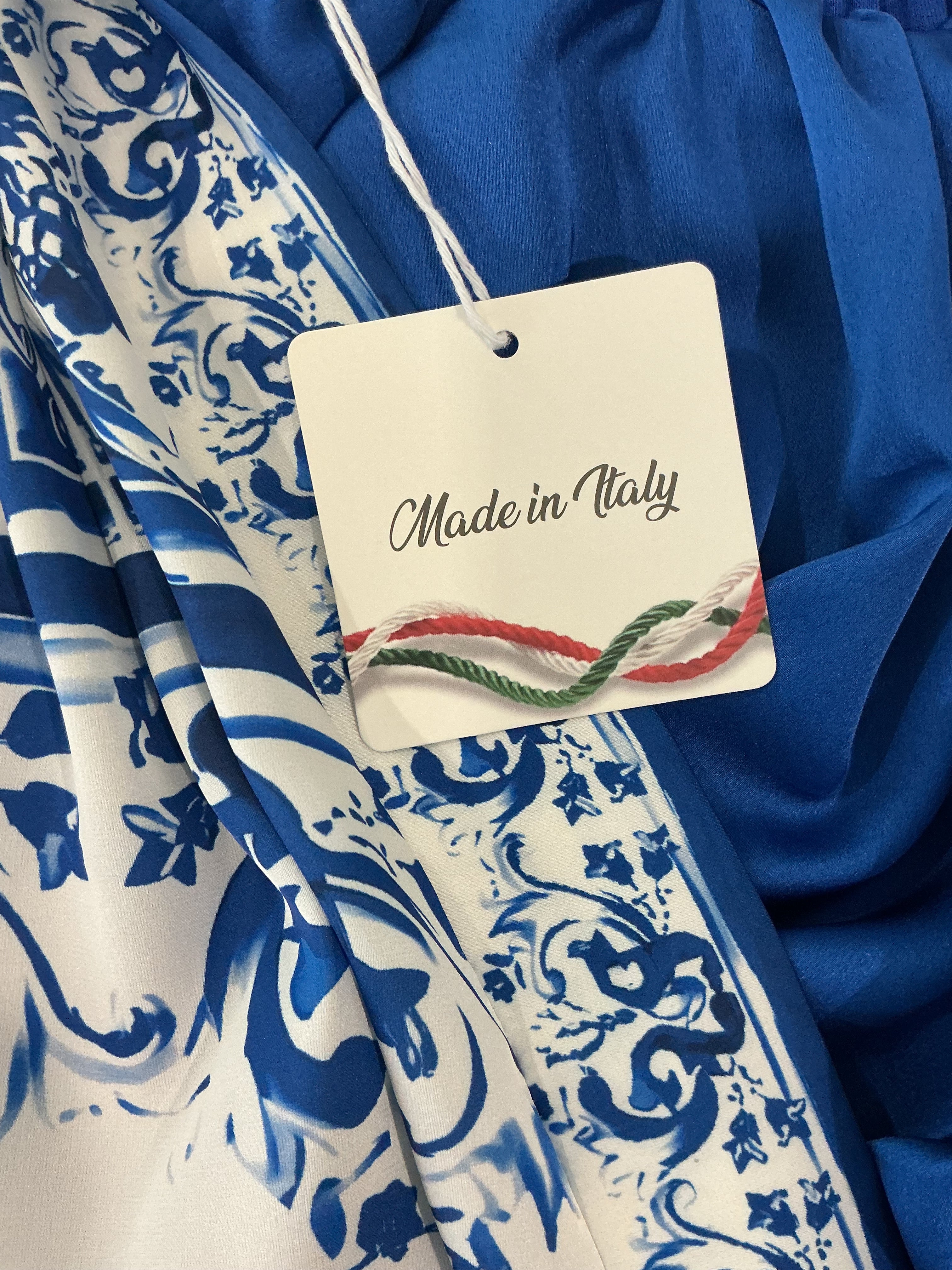 Blue and white patterned fabric with a 'Made in Italy' tag.